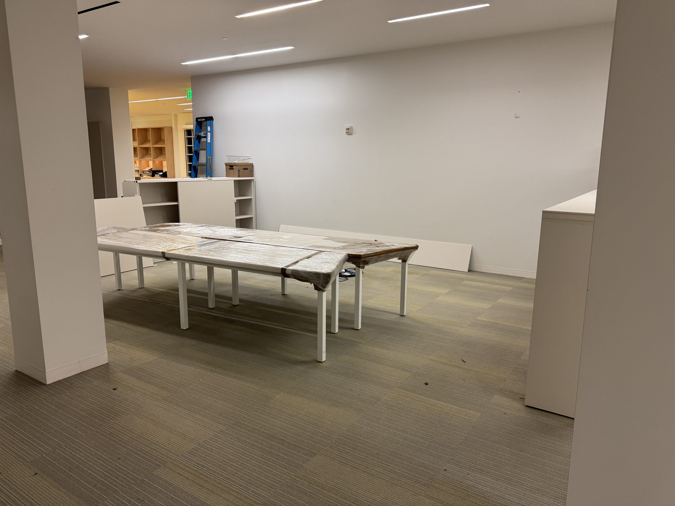 Protected office tables staged for organized placement